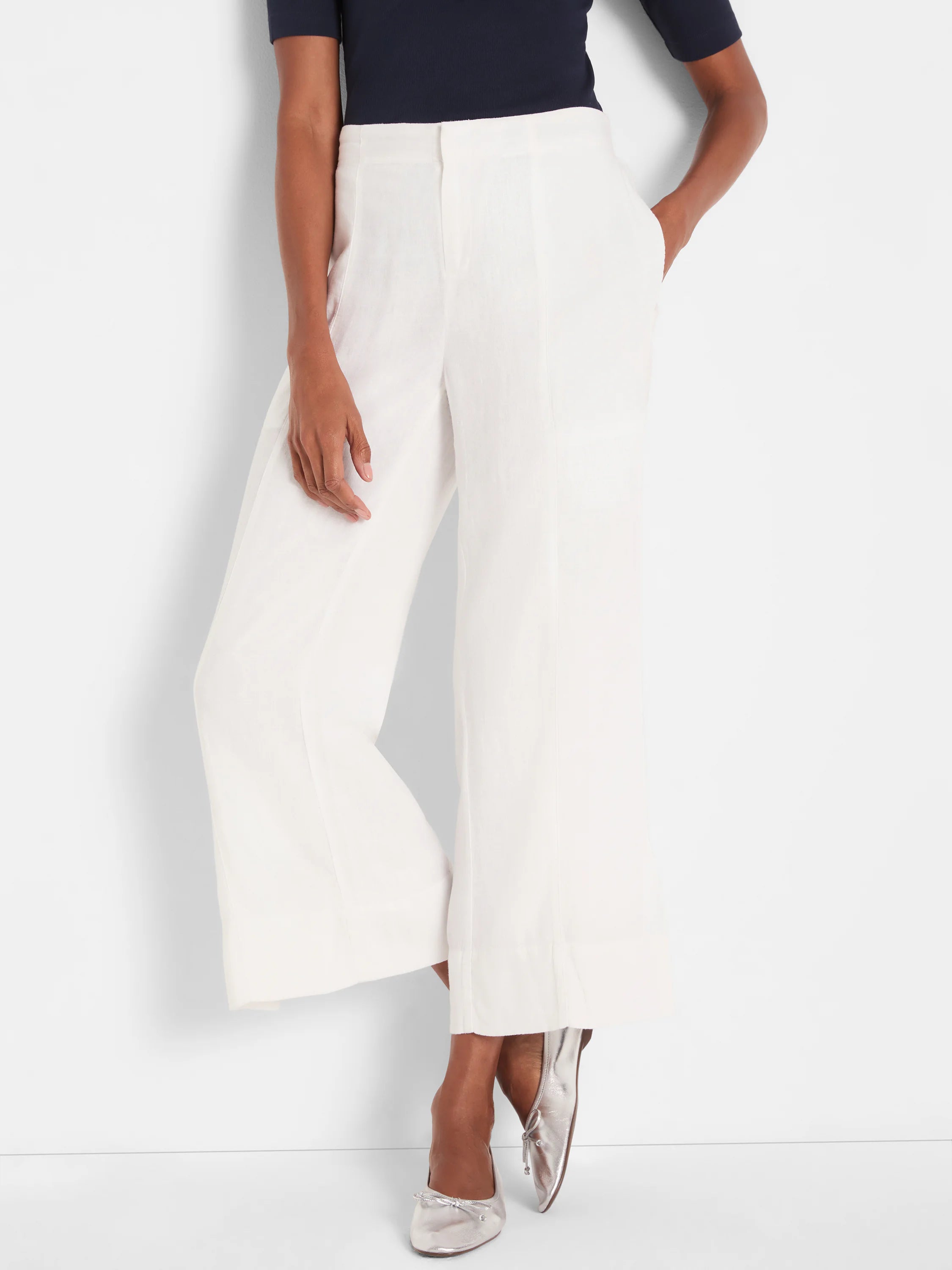 Off-white wide-leg crop pants in a textured fabric, with a flat front and subtle side pockets.