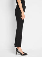 Black demi bootcut pants. Fitted through the thigh, subtly flares at hem, full length.