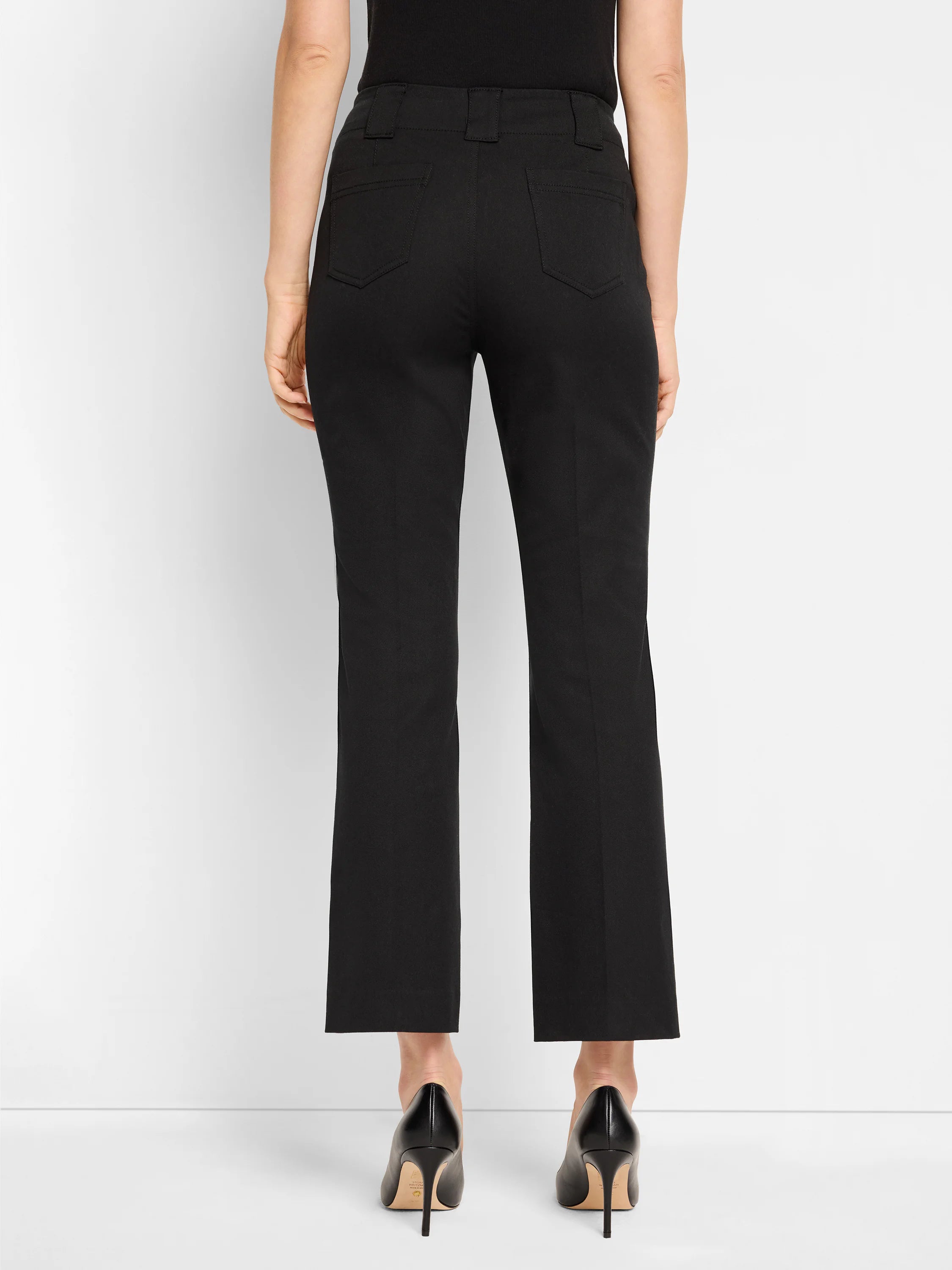 Black demi-boot pants, rear view. Features back patch pockets with topstitching and belt loops. Cropped length.