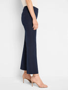 Navy blue demi bootcut pants, cropped above the ankle, with belt loops, seen from the side.