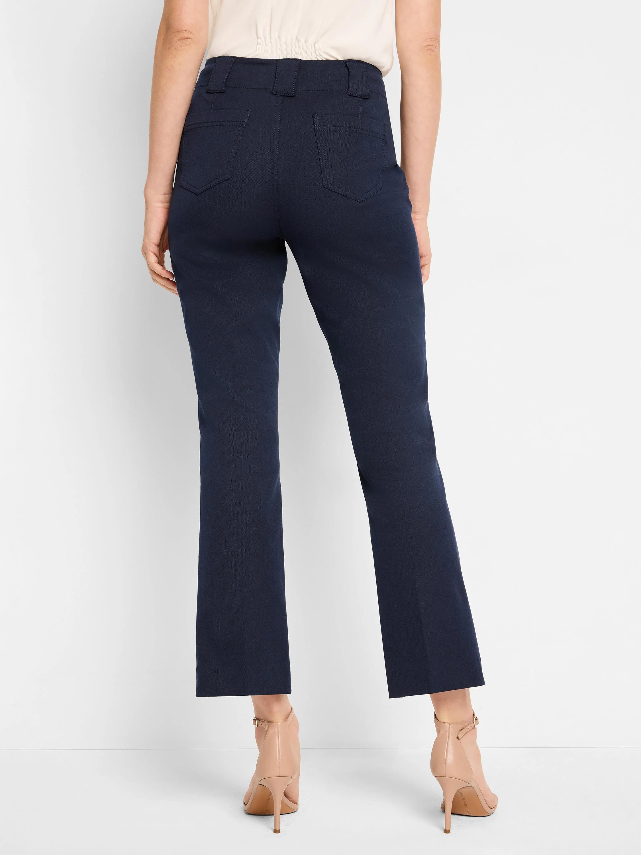 Dark blue demi-boot cropped pants seen from behind, featuring back patch pockets and belt loops.