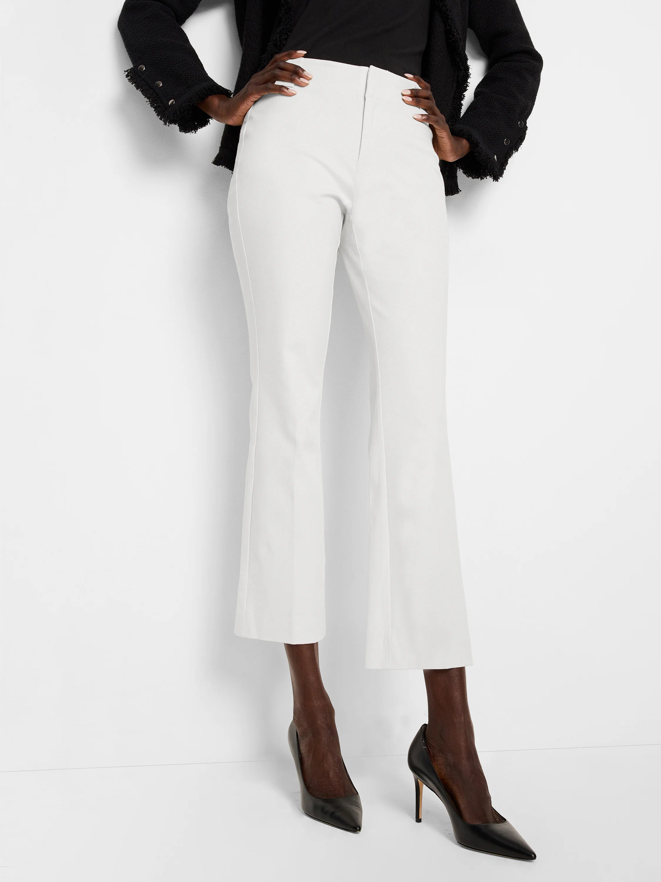 White cropped demi-boot pants, smooth bi-stretch fabric, flat front with pressed leg creases.