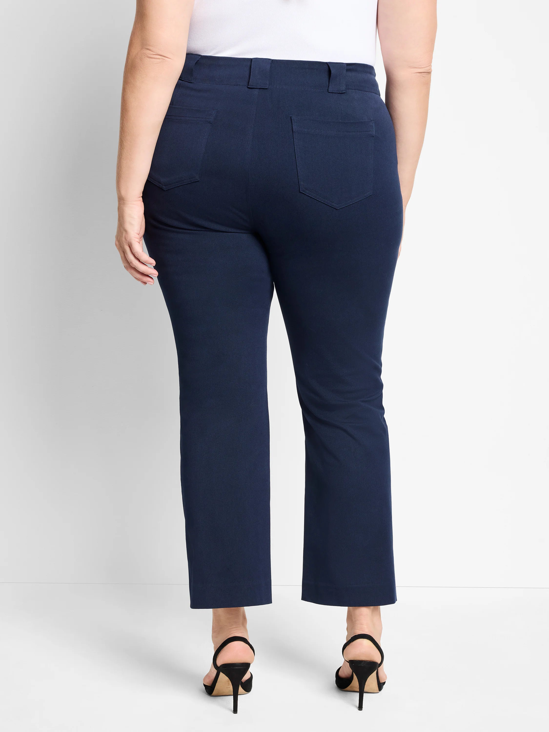 Rear view of navy demi boot cut pants. Slim fit with belt loops and two back patch pockets.