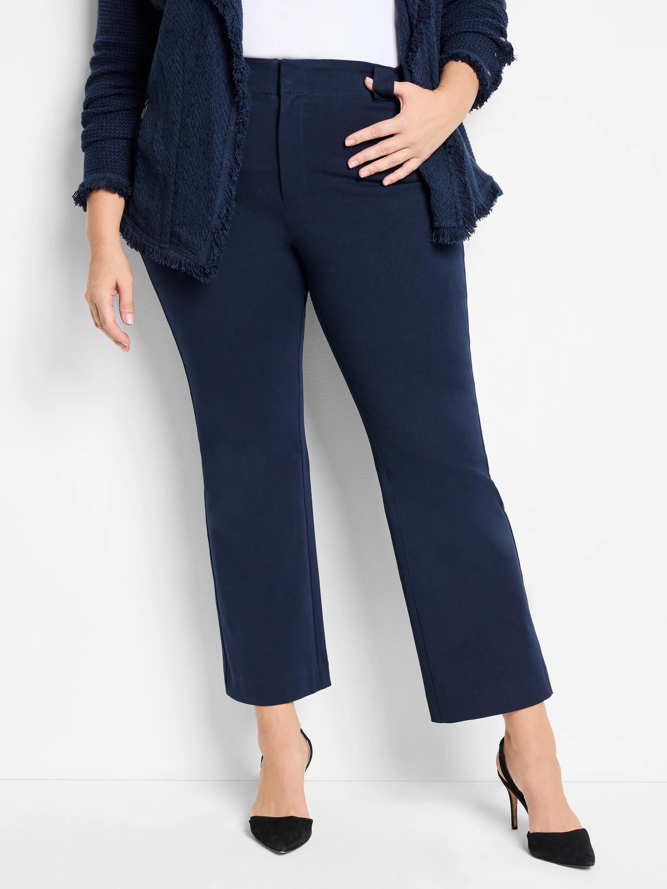 Dark blue, smooth demi boot pants with a flat front and subtle flare above the ankle.