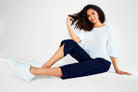 Dark wash wide-leg cropped jeans shown on a model.  The jeans are dark blue.