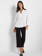 Black wide-leg crop pants made of a smooth fabric.