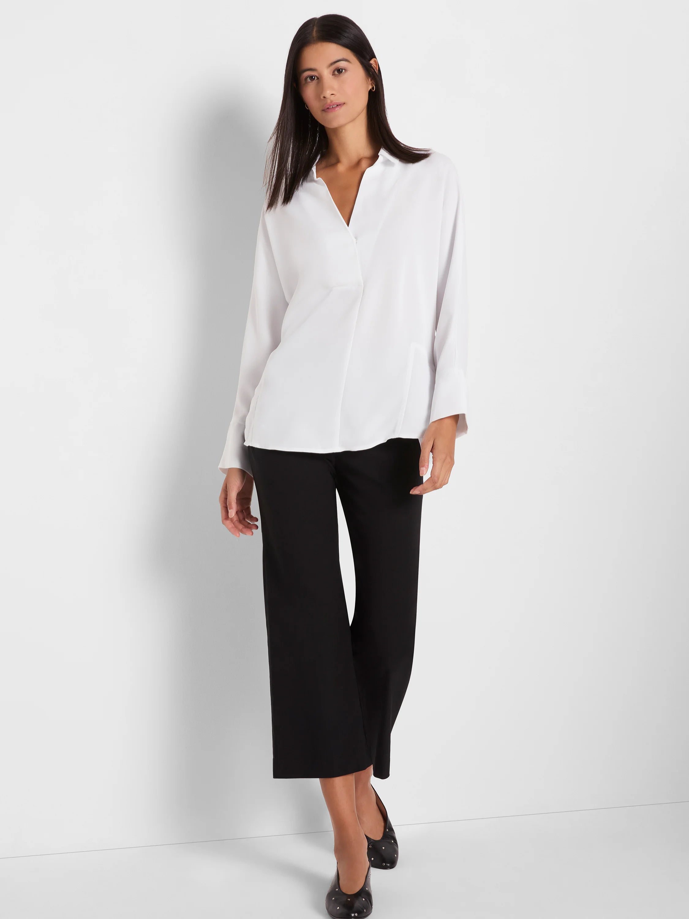 Black wide-leg crop pants made of a smooth fabric.