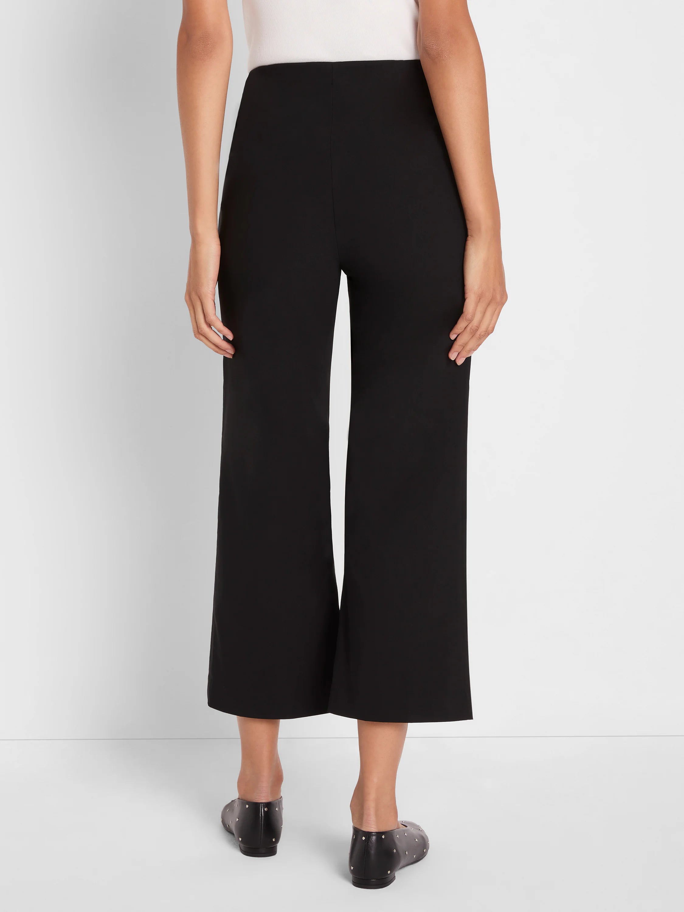 Black polished wide-leg crop pants, above-ankle length.