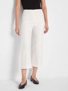 Off-white wide-leg crop pants with a smooth finish, worn high-waisted and ending at mid-calf.