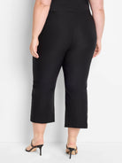 Black wide-leg crop pants shown from behind. Smooth fabric, cropped above the ankle.