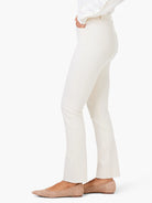 Off-white straight ankle jeans with a visible frayed hem, worn on a model.