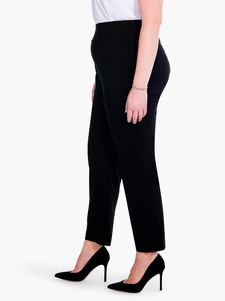 Black straight leg pants on a model. Features a smooth, wide waistband and subtle side pockets.