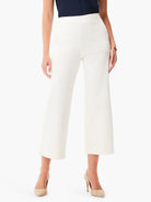 White wide-leg jeans, cropped length, with visible front seams and two patch pockets.