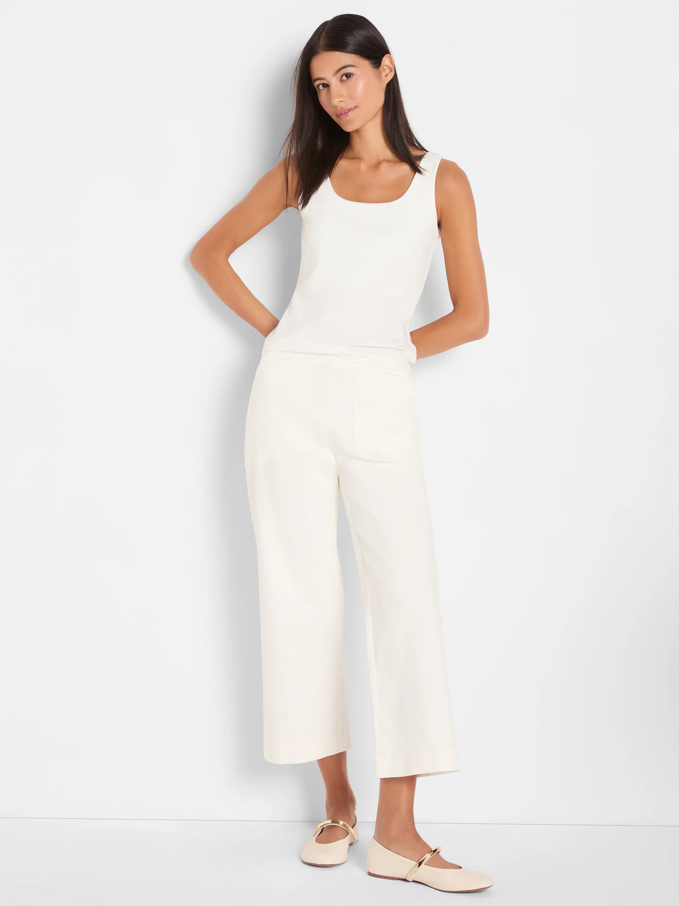 Cream wide-leg jeans, cropped at the ankle with a front seam, worn by a model with a matching tank top.