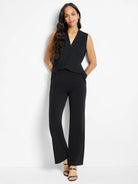 Black wide-leg trousers. Full length, smooth fabric, shown on a model.