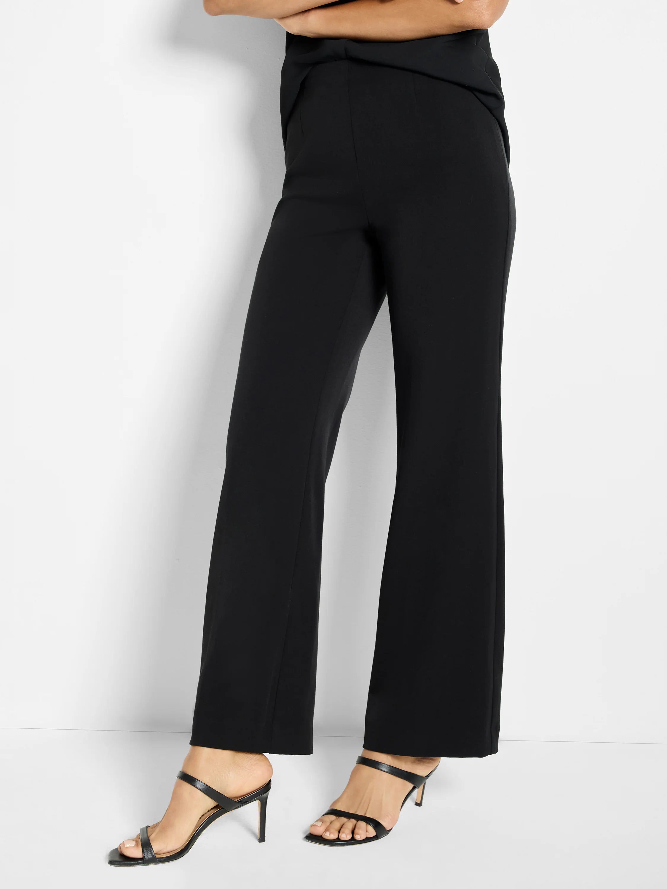 Black wide-leg trousers, high-waisted, with a smooth fabric texture, shown on a model.
