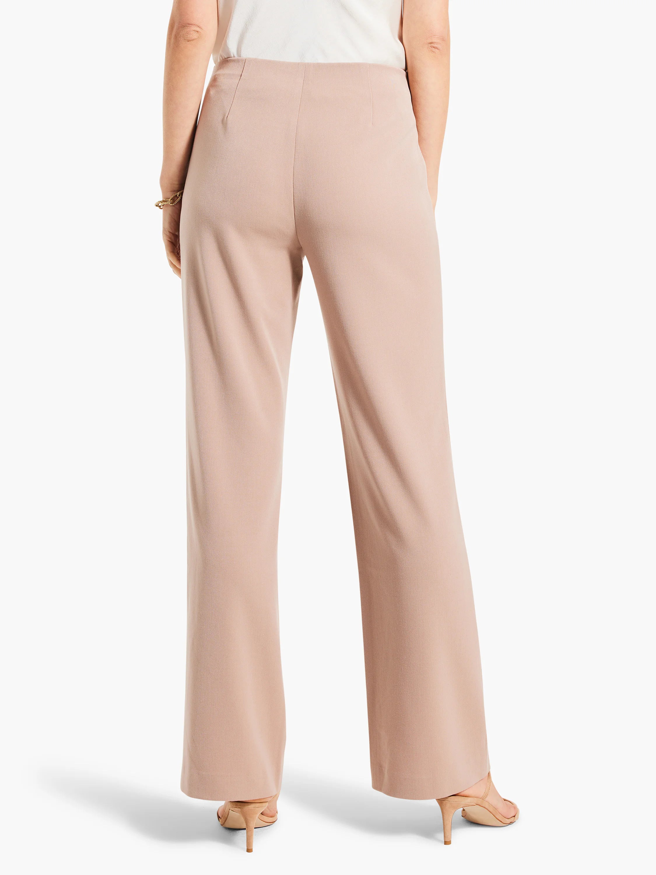 Pale beige wide leg trousers, high-waisted with smooth fabric, shown on model from behind.