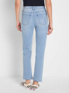 Back view: light blue mid-rise girlfriend jeans with straight, cropped legs and stitched back pockets.