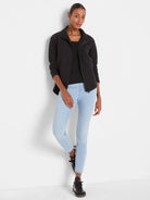 Light blue mid-rise slim ankle jeans with a smooth denim finish.