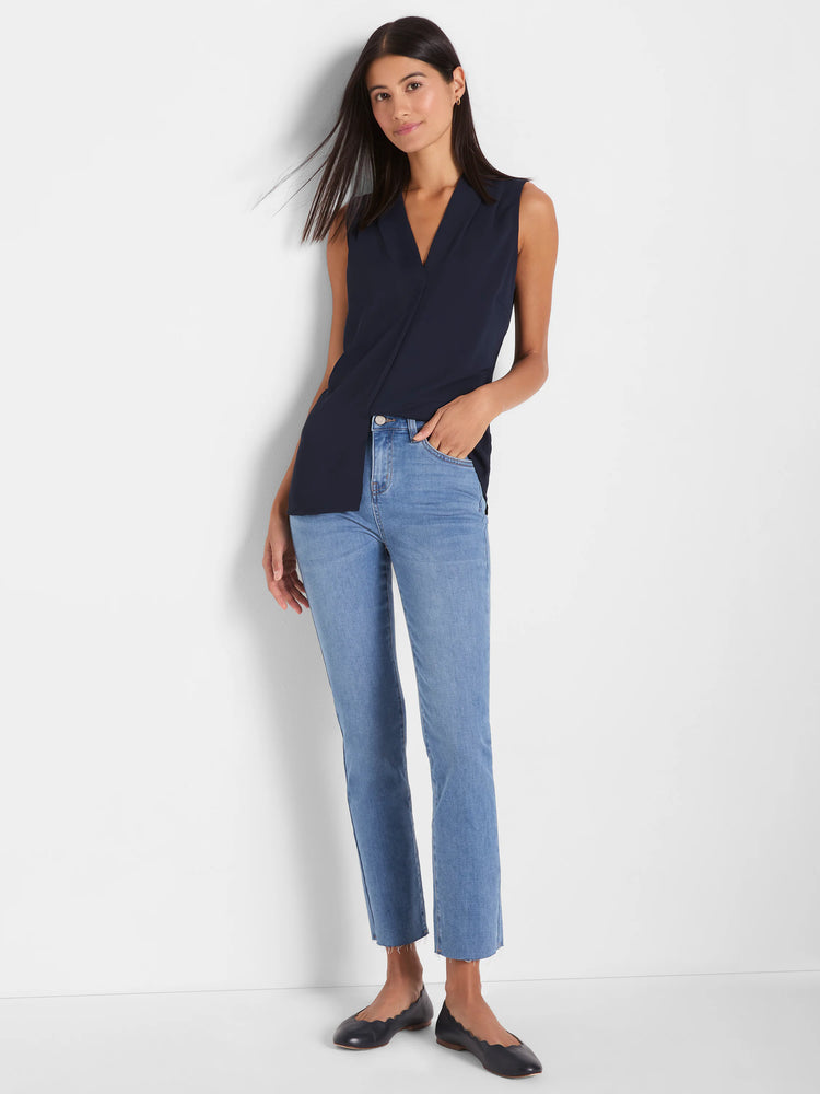 Light wash denim straight ankle jeans featuring frayed hems.