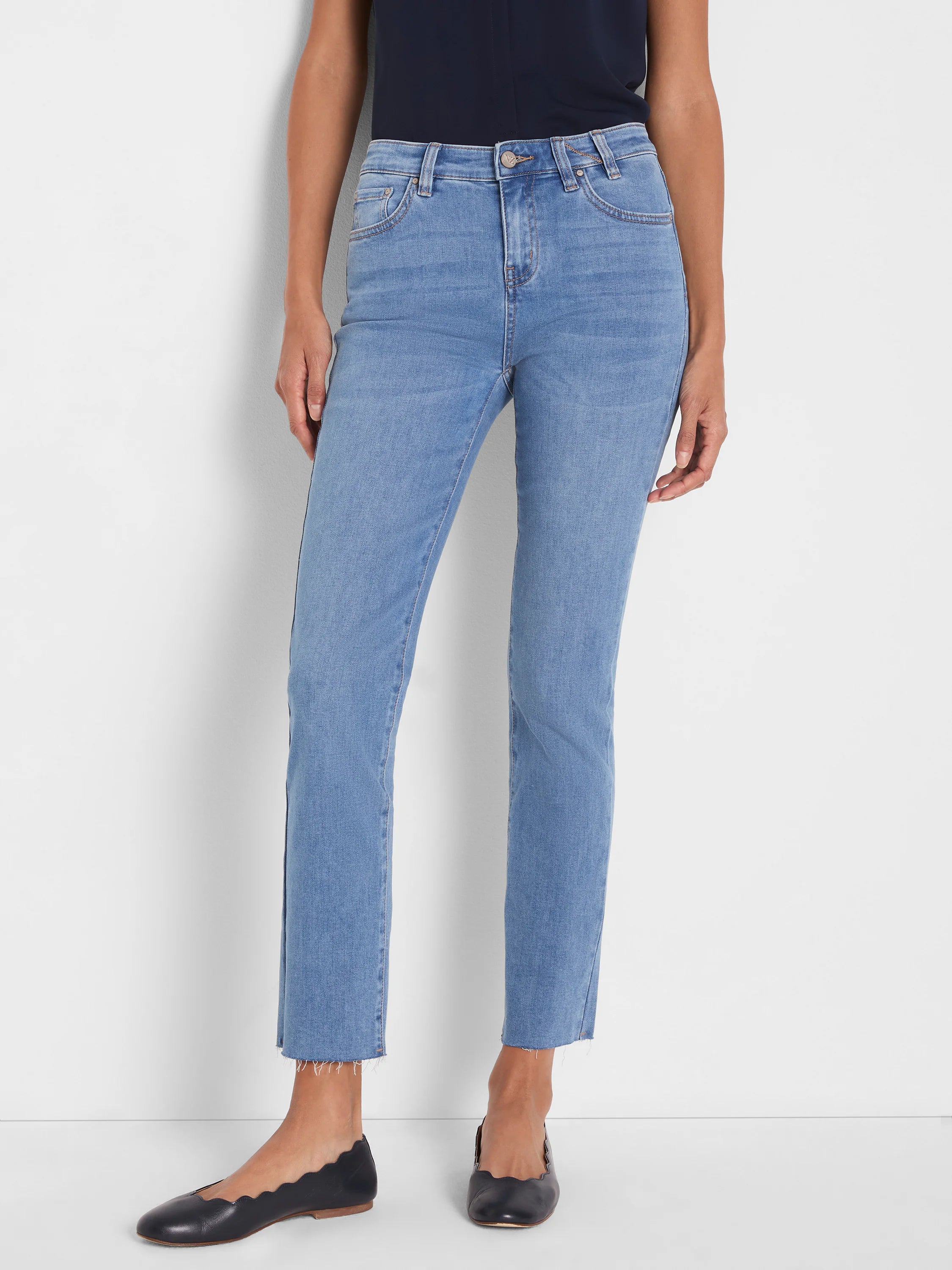 Light blue straight ankle jeans with a raw, frayed hem.