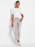Pale grey straight ankle jeans with a frayed hem.
