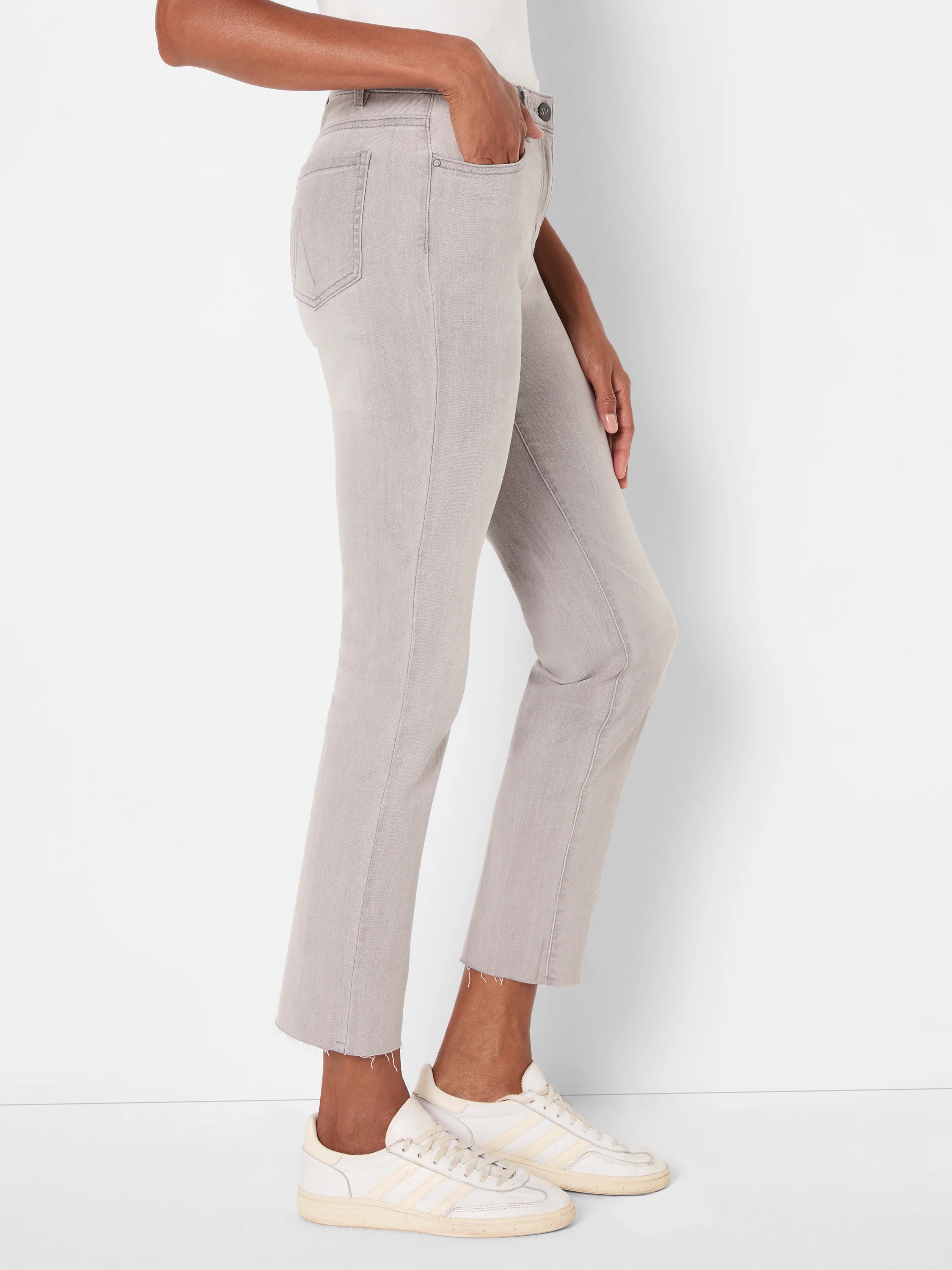 Pale gray straight ankle jeans with frayed hems.