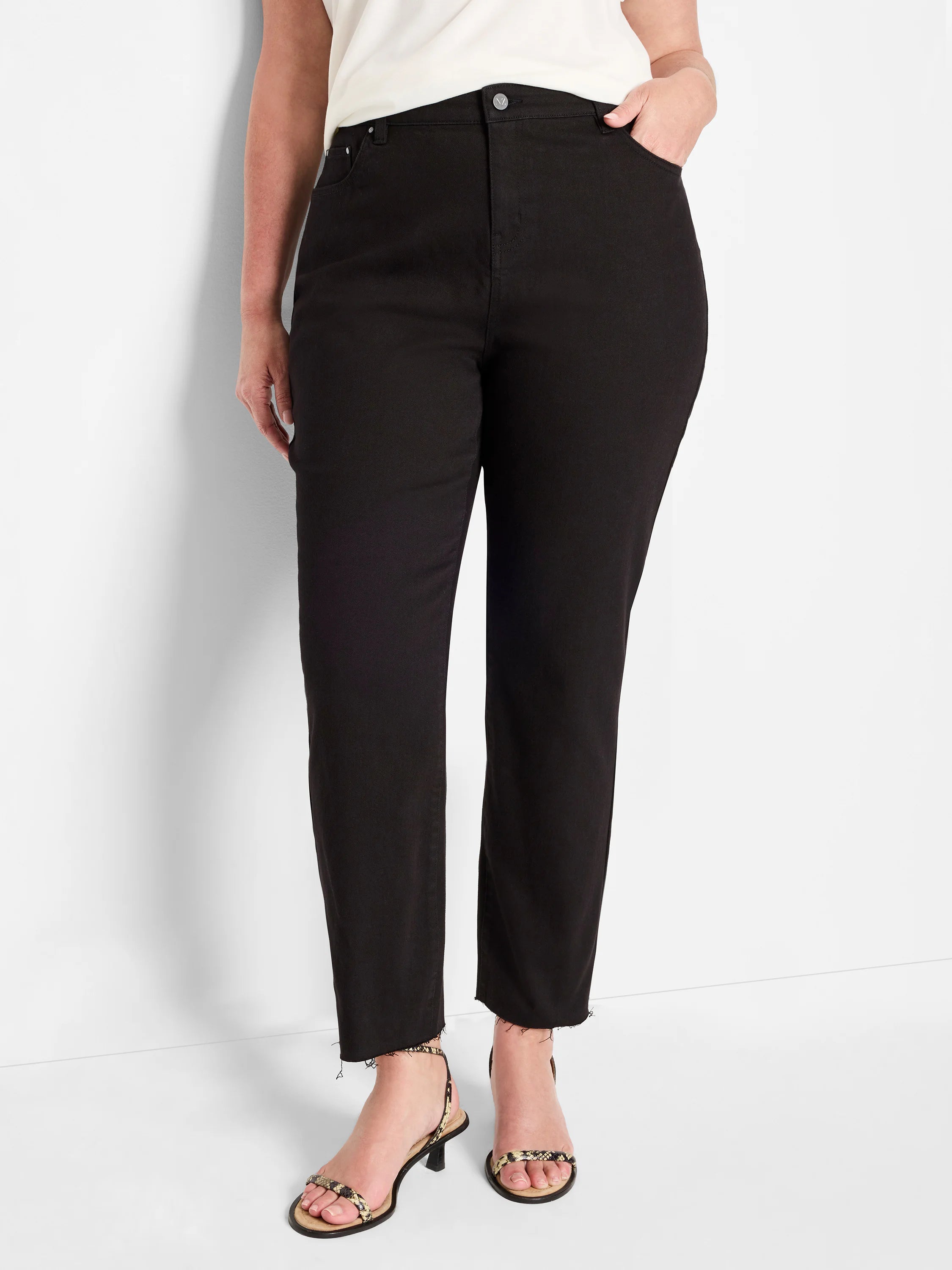 Black straight ankle jeans with frayed hems.