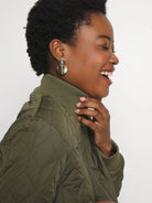 Olive green quilted coat with ribbed collar and trim.  Diamond quilting pattern.