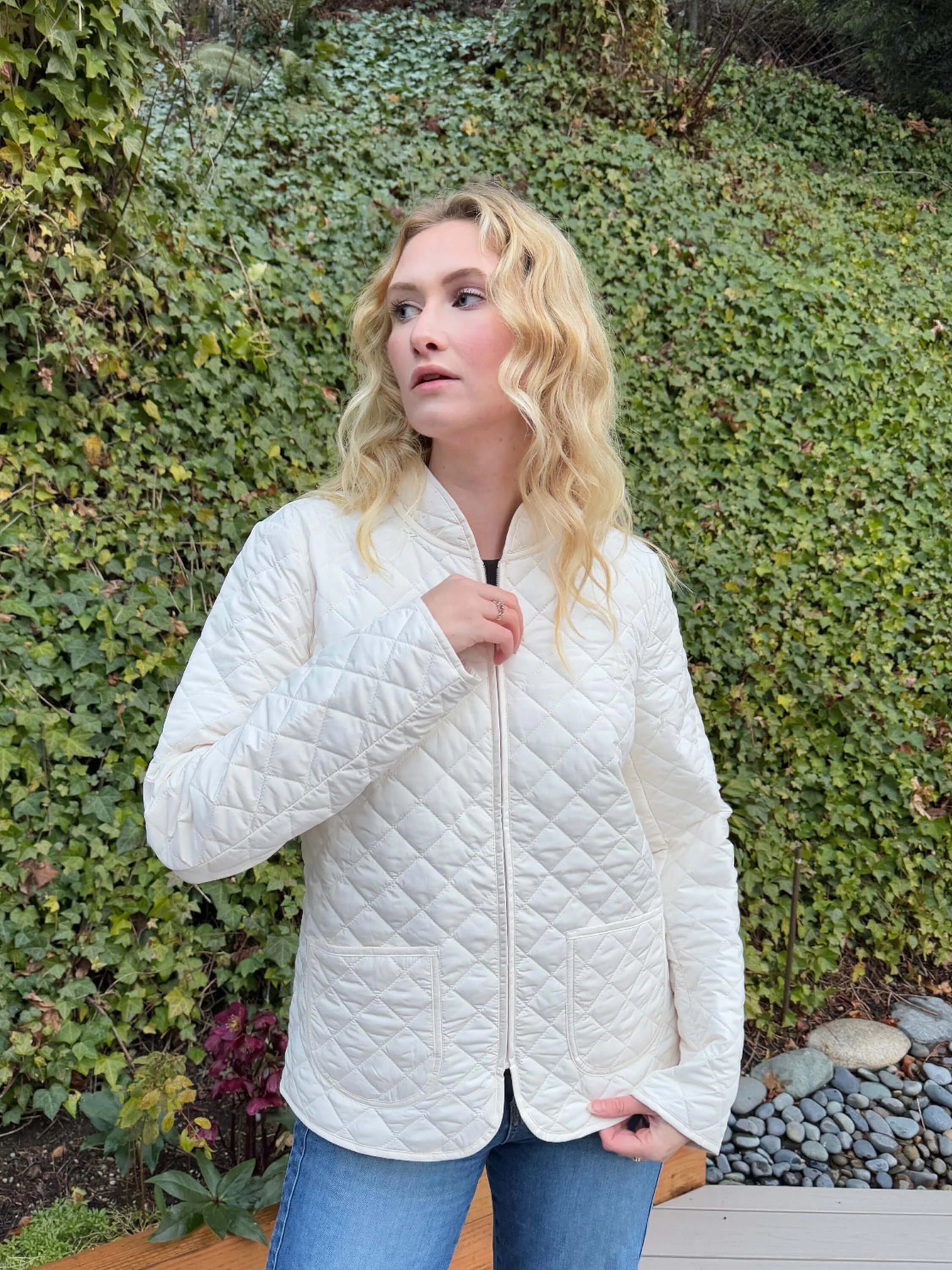 Off-white quilted short coat, diamond pattern, zipper closure, hip length, two patch pockets.