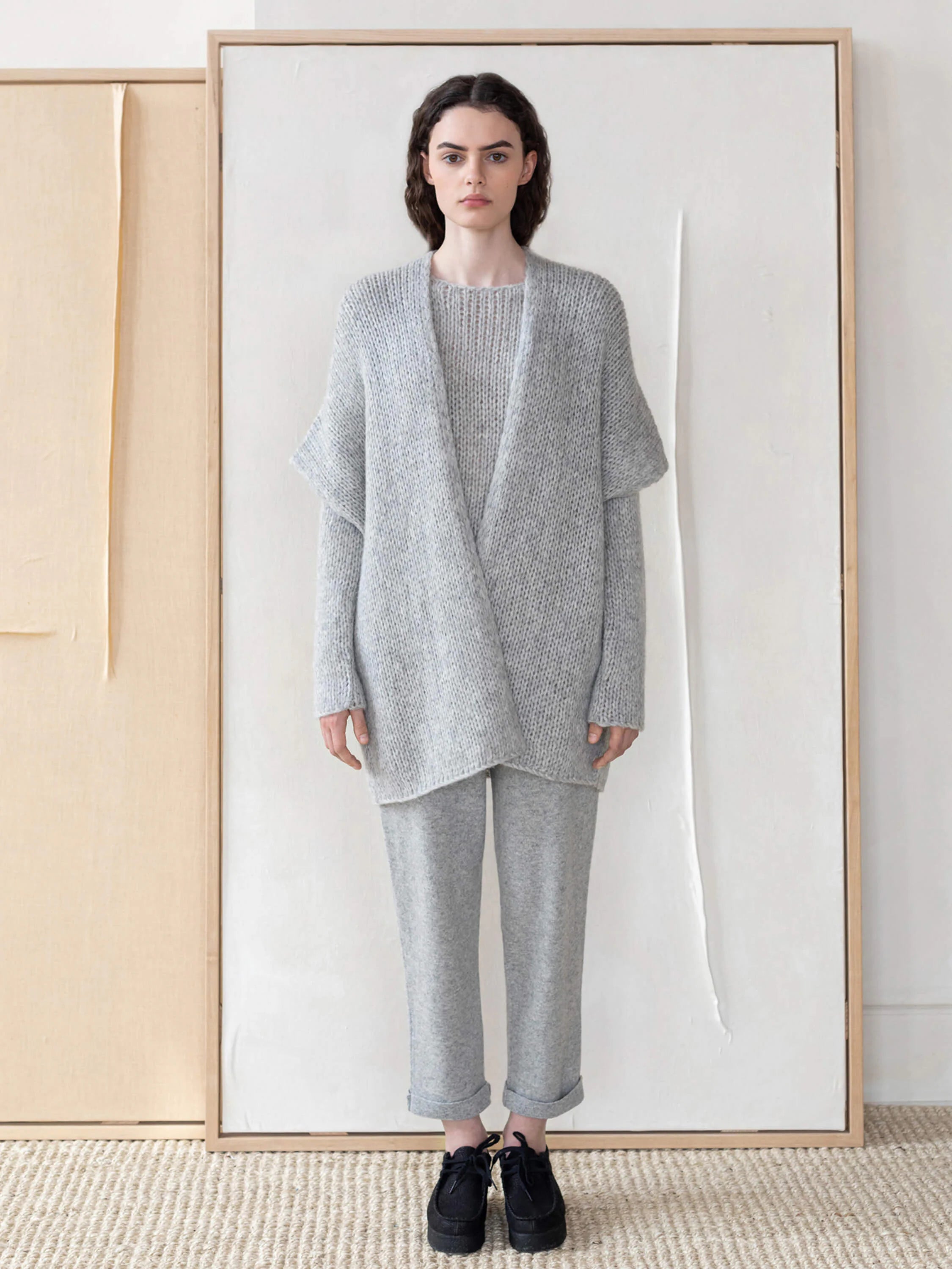 Light gray, loosely knit, open-front vest.  Relaxed fit, slightly dolman sleeves.
