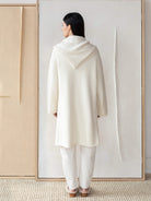 Off-white alpaca hooded coat, knee-length, shown from the back.  Features a large hood.