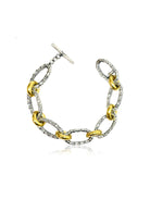 Two-toned bracelet: silver and gold oval links, textured finish, toggle clasp.