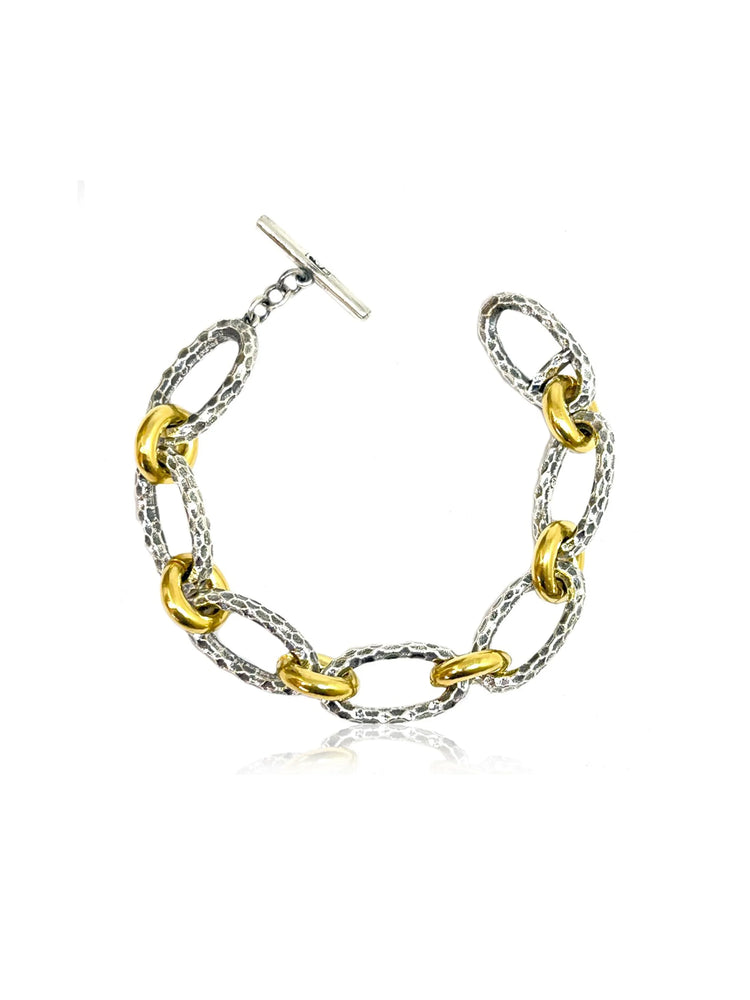 Two-toned bracelet: silver and gold oval links, textured finish, toggle clasp.