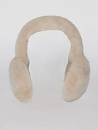 Cream-colored faux fur earmuffs featuring a plush, fluffy headband and rounded earcups.