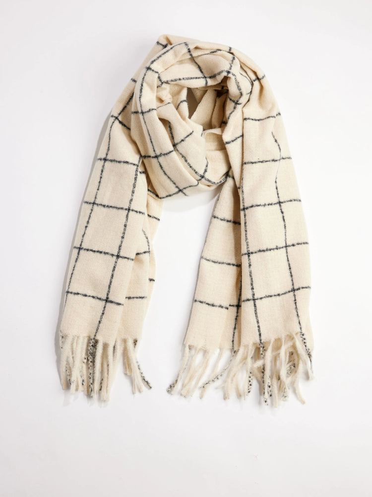 Cream muffler scarf with dark windowpane pattern and fringed ends.