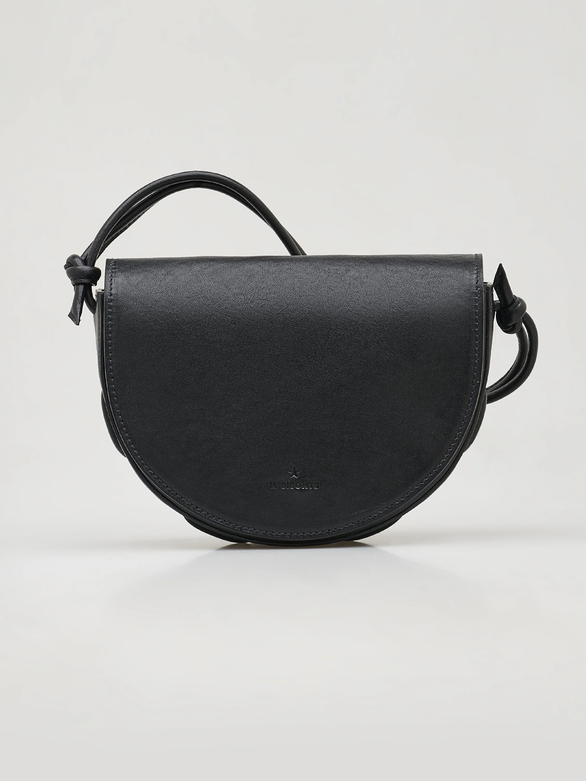 Black leather half-moon crossbody bag with knotted strap and subtle logo.
