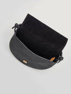 Black half-moon crossbody bag with knotted strap, black suede interior, and gold clasp.