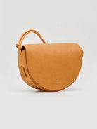 Light brown leather half-moon crossbody bag with a small top handle.  Subtle logo.