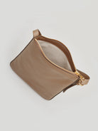 Here's alt text for the image, under 125 characters:

"Tan leather crossbody bag with gold zipper & strap.  Interior is...