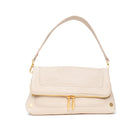 Textured cream leather shoulder bag with a fold-over flap, front gold zipper, and gold hardware.