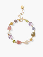 Gold chain bracelet with pink, purple, green, and white stones; varied shapes and sizes.