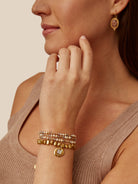 Champagne, gold, and grey pearl bracelet with gold beads and charm.  Layered design.