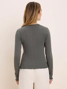 Sage green fitted long sleeve tee with pointelle rib texture and wavy lettuce-edge trim.
