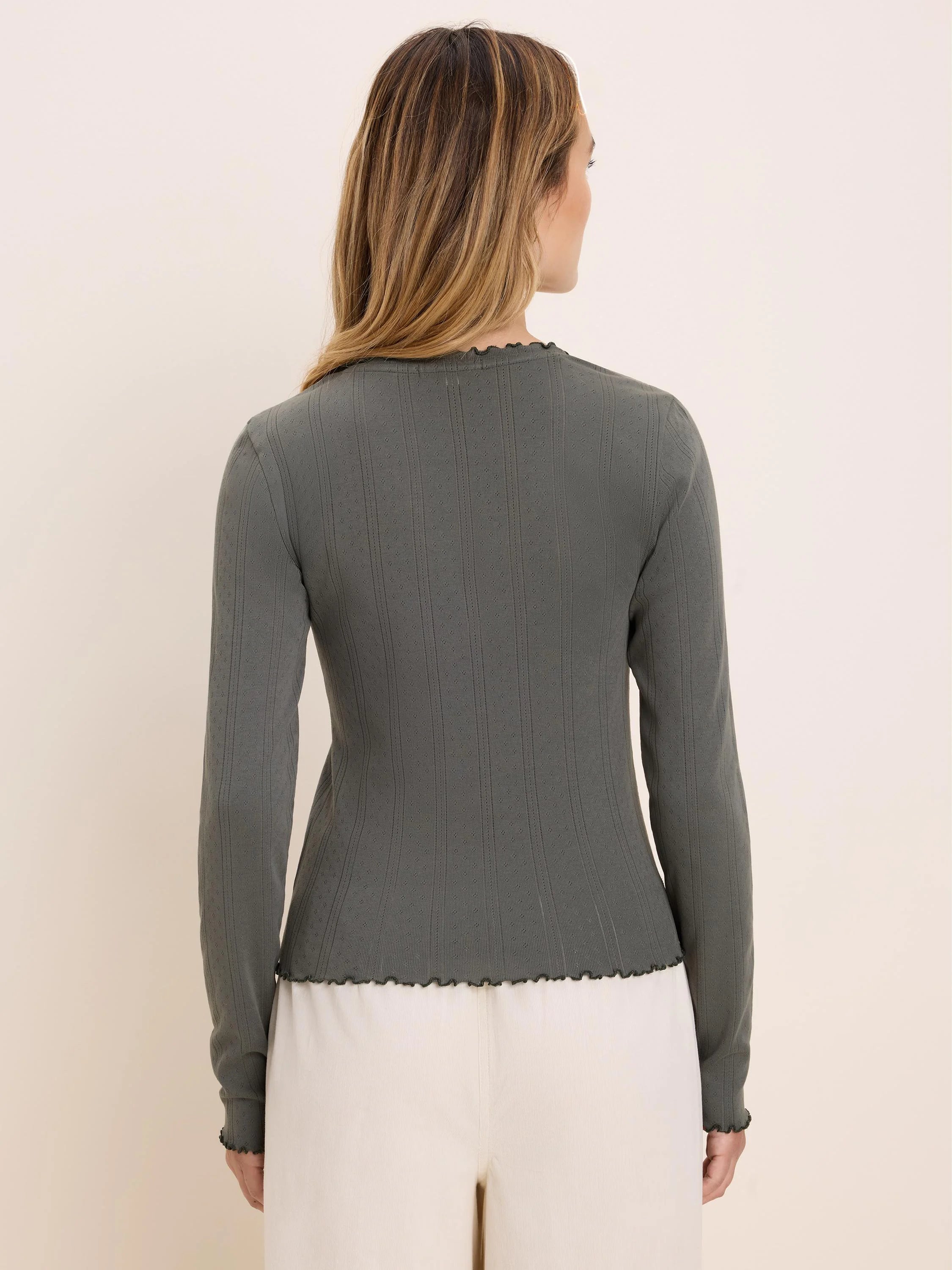 Sage green fitted long sleeve tee with pointelle rib texture and wavy lettuce-edge trim.