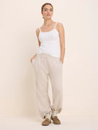 White pointelle rib camisole with thin straps and delicate trim on neckline.
