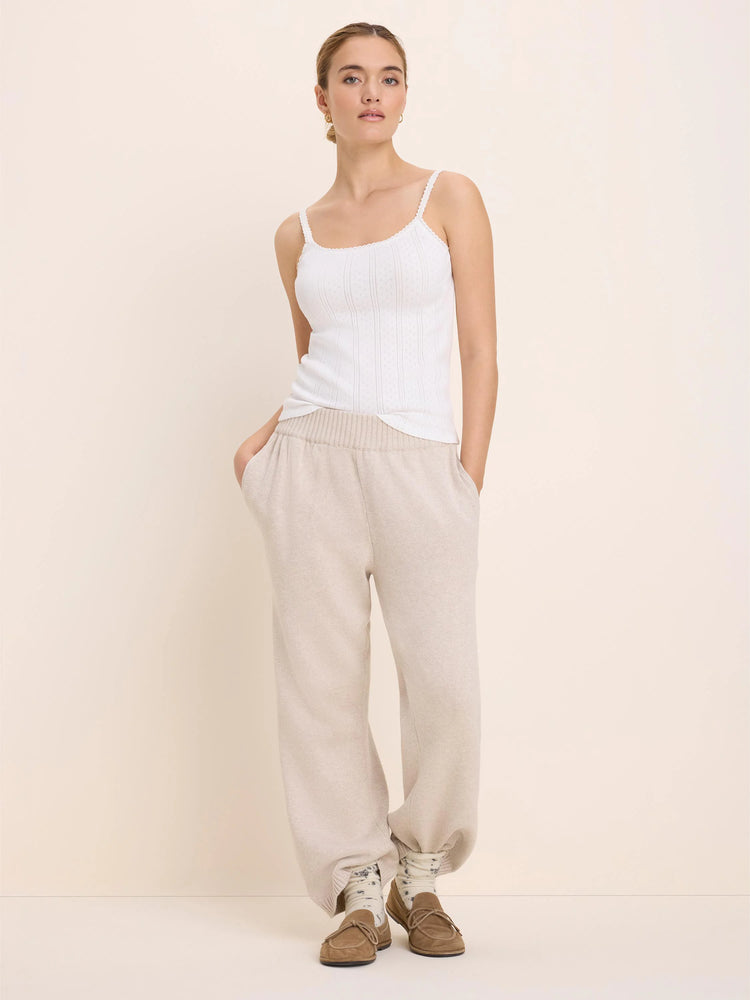 White pointelle rib camisole with thin straps and delicate trim on neckline.