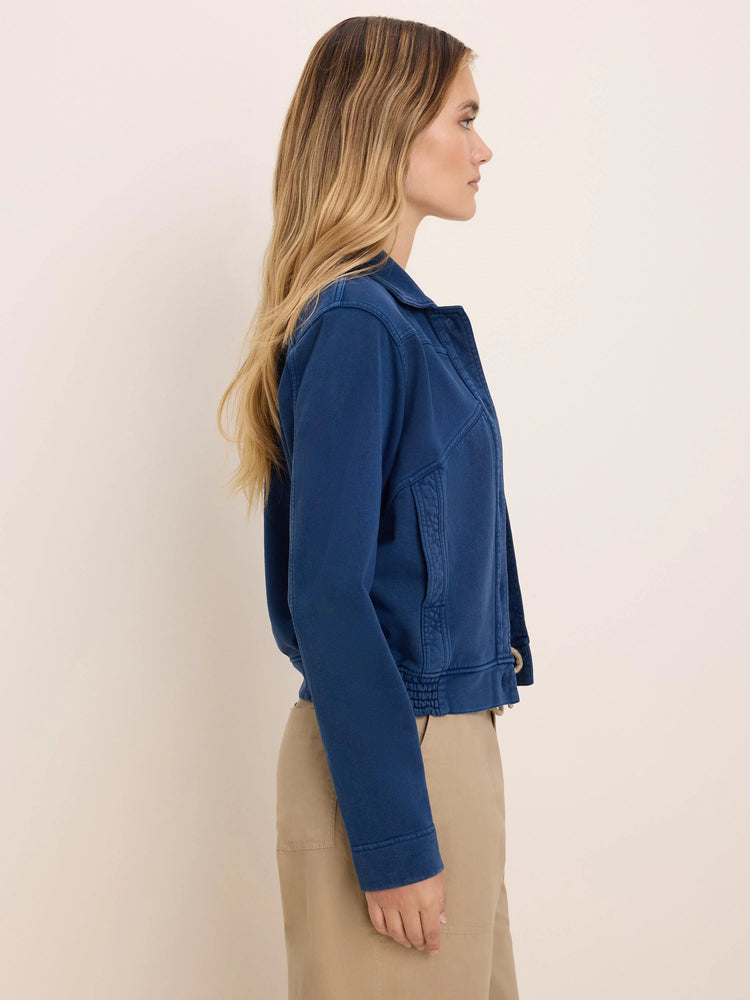 Deep blue terry jacket with prominent stitching, a shirt collar, and an elasticated hem and cuffs.