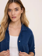 Navy blue terry collared jacket with silver snap buttons and visible seam details.