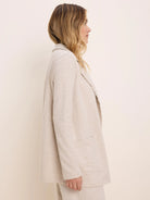 Heathered oatmeal long jacket with soft lapel collar, open front, and two patch pockets with raw edge detailing.